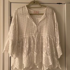 White eyelet blouse with tie front. No size but fits like a traditional M/L